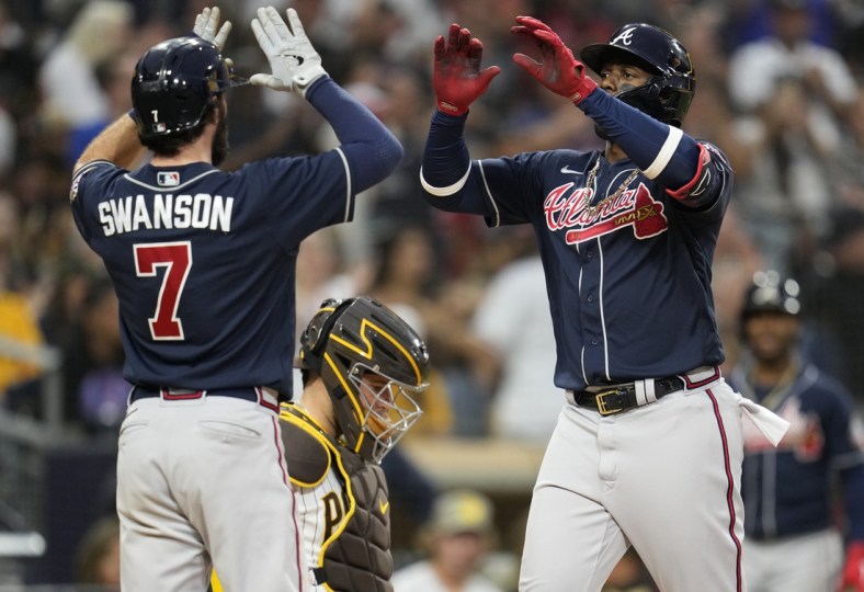 Sep 25, 2021; San Diego, California, USA;  Atlanta Braves right fielder Jorge Soler (12) celebrates his two run home run against the San Diego Padres with shortstop Dansby Swanson (left) during the sixth inning at Petco Park. Mandatory Credit: Ray Acevedo-USA TODAY Sports