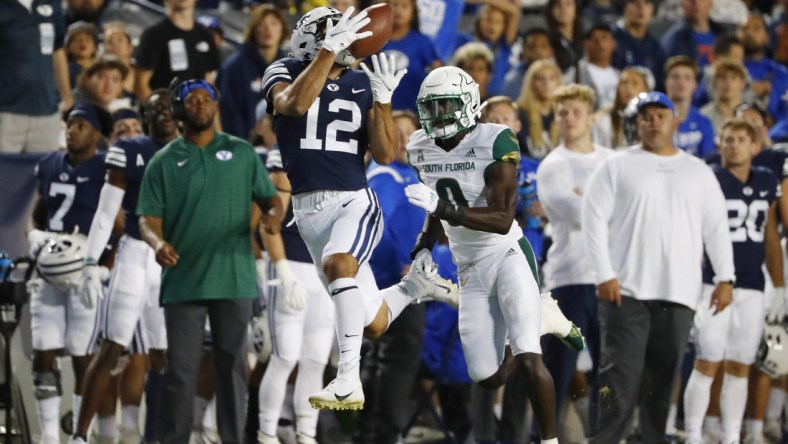 Sep 25, 2021; Provo, Utah, USA; Brigham Young Cougars wide receiver Puka Nacua (12) makes a reception for a first down past DUPLICATE***South Florida Bulls defensive back Daquan Evans (0)***South Florida Bulls running back Jaren Mangham (0) in the first quarter at LaVell Edwards Stadium. Mandatory Credit: Jeffrey Swinger-USA TODAY Sports