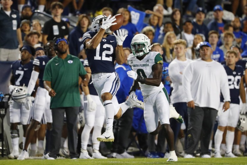 Sep 25, 2021; Provo, Utah, USA; Brigham Young Cougars wide receiver Puka Nacua (12) makes a reception for a first down past DUPLICATE***South Florida Bulls defensive back Daquan Evans (0)***South Florida Bulls running back Jaren Mangham (0) in the first quarter at LaVell Edwards Stadium. Mandatory Credit: Jeffrey Swinger-USA TODAY Sports