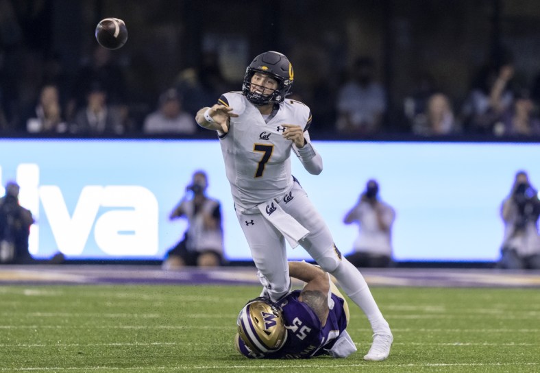 Sep 25, 2021; Seattle, Washington, USA;  California Golden Bears quarterback Chase Garbers (7) throws a passes before getting sacked by Washington Huskies linebacker Ryan Bowman (55) during the first half of a game at Alaska Airlines Field at Husky Stadium. Mandatory Credit: Stephen Brashear-USA TODAY Sports