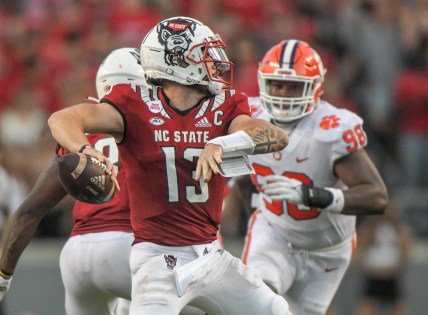 NC State quarterback Devin Leary (13) passes near Clemson defensive end Myles Murphy (98) during the fourth quarter at Carter-Finley Stadium in Raleigh, N.C., September 25, 2021.  The Tigers lost 27-21 in two overtimes game at Carter-Finley Stadium in Raleigh, N.C., September 25, 2021. Leary  was 32-44 for 238  yards and four touchdown passes.

Ncaa Football Clemson At Nc State