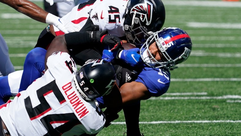 Sep 26, 2021; E. Rutherford, N.J., USA;  New York Giants wide receiver Collin Johnson (15) carries the ball as Atlanta Falcons linebacker Deion Jones (45) and Atlanta Falcons linebacker Foye Oluokun (54) tackle in the first half at MetLife Stadium. Mandatory Credit: Robert Deutsch-USA TODAY Sports