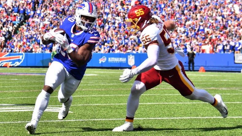 Sep 26, 2021; Orchard Park, New York, USA; Buffalo Bills running back Zack Moss (20) scores a touchdown beating Washington Football Team linebacker Cole Holcomb (55) to the end zone in the second quarter at Highmark Stadium. Mandatory Credit: Mark Konezny-USA TODAY Sports