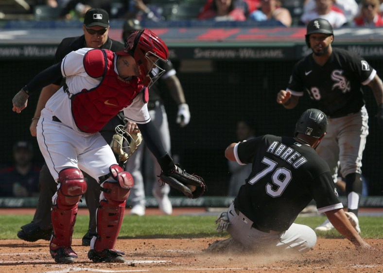 Sep 26, 2021; Cleveland, Ohio, USA;  Chicago White Sox Jose Abreu (79) slides into home plate safe ahead of the tag from Cleveland Indians catcher Roberto Prez (55) in the third inning at Progressive Field. Mandatory Credit: Aaron Josefczyk-USA TODAY Sports
