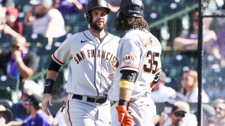 Sep 26, 2021; Denver, Colorado, USA; San Francisco Giants first baseman Brandon Belt (9) celebrates with shortstop Brandon Crawford (35) after scoring against the Colorado Rockies off a hit by left fielder Kris Bryant (23) in the fifth inning at Coors Field. Mandatory Credit: Michael Ciaglo-USA TODAY Sports
