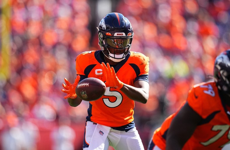 Sep 26, 2021; Denver, Colorado, USA; Denver Broncos quarterback Teddy Bridgewater (5) takes a snap in the second quarter against the New York Jets at Empower Field at Mile High. Mandatory Credit: Ron Chenoy-USA TODAY Sports