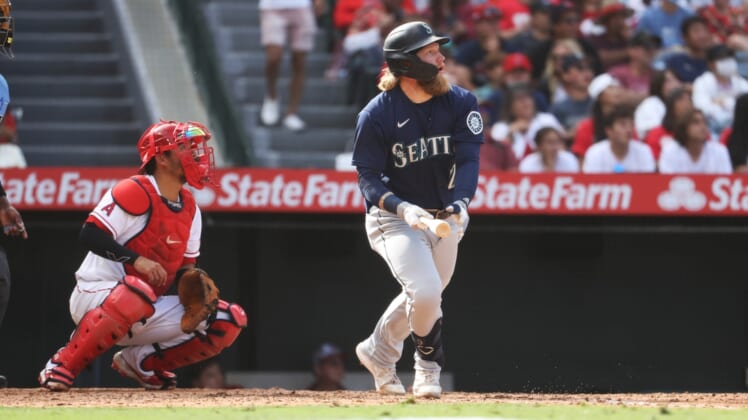 Sep 26, 2021; Anaheim, California, USA; Seattle Mariners left fielder Jake Fraley (28) hits a double against the Los Angeles Angels in the eighth inning at Angel Stadium. Mandatory Credit: Kiyoshi Mio-USA TODAY Sports