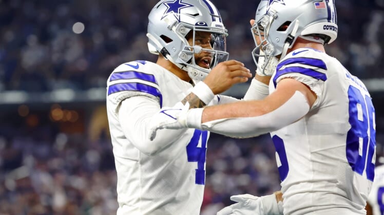 Sep 27, 2021; Arlington, Texas, USA; Dallas Cowboys quarterback Dak Prescott (4) celebrates with wide receiver CeeDee Lamb (88) after a touchdown pass against the Philadelphia Eagles during the first quarter at AT&T Stadium. Mandatory Credit: Kevin Jairaj-USA TODAY Sports