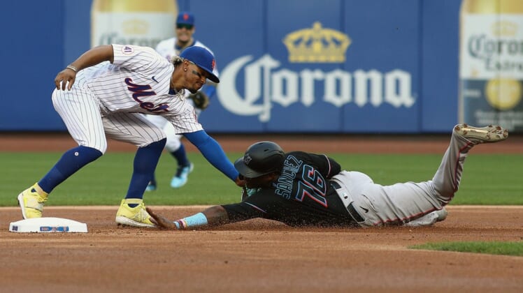 Sep 28, 2021; New York City, New York, USA; Miami Marlins right fielder Jesus Sanchez (76) is tagged out by New York Mets shortstop Francisco Lindor (12) attempting to steal second base during the first inning of game one of a doubleheader at Citi Field. Mandatory Credit: Andy Marlin-USA TODAY Sports
