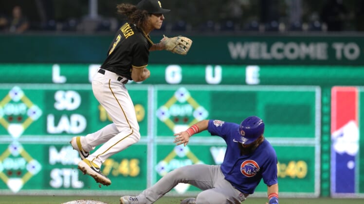 Sep 28, 2021; Pittsburgh, Pennsylvania, USA;  Pittsburgh Pirates second baseman Cole Tucker (3) avoids the slide of Chicago Cubs right fielder Nick Martini (62) after throwing to first base to complete a double pay during the second inning at PNC Park. Mandatory Credit: Charles LeClaire-USA TODAY Sports