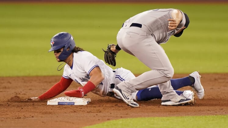 Sep 28, 2021; Toronto, Ontario, CAN; Toronto Blue Jays shortstop Bo Bichette (11) steals second base against New York Yankees second baseman Gleyber Torres (25) during the first inning at Rogers Centre. Mandatory Credit: John E. Sokolowski-USA TODAY Sports