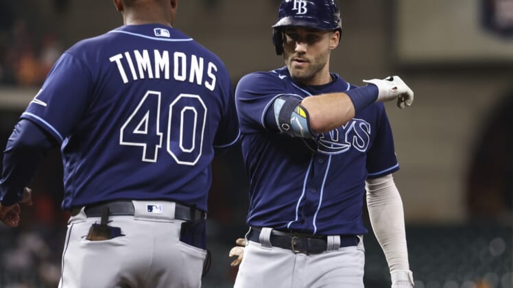Sep 28, 2021; Houston, Texas, USA; Tampa Bay Rays center fielder Kevin Kiermaier (39) celebrates with first base coach Ozzie Timmons (40) after hitting a single against the Houston Astros during the second inning at Minute Maid Park. Mandatory Credit: Troy Taormina-USA TODAY Sports