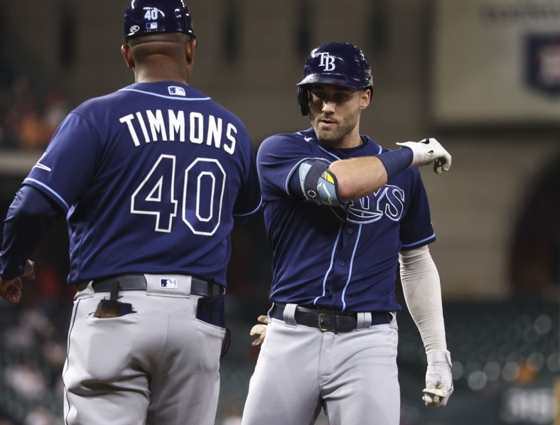Sep 28, 2021; Houston, Texas, USA; Tampa Bay Rays center fielder Kevin Kiermaier (39) celebrates with first base coach Ozzie Timmons (40) after hitting a single against the Houston Astros during the second inning at Minute Maid Park. Mandatory Credit: Troy Taormina-USA TODAY Sports