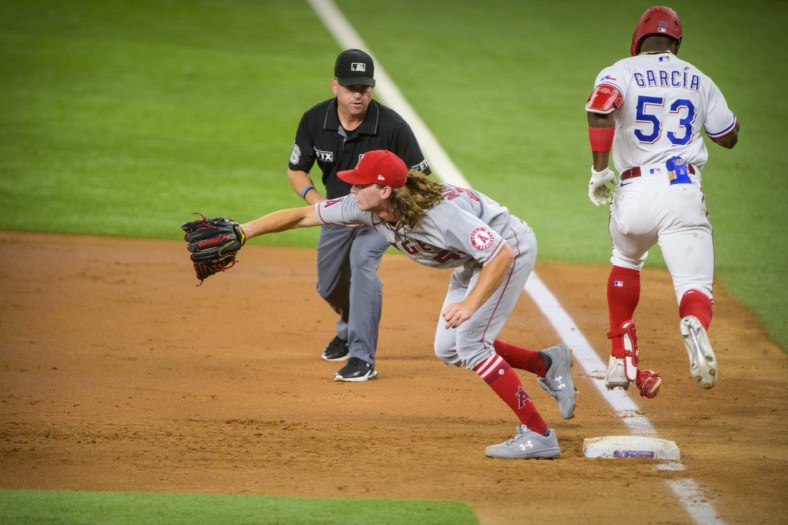 Sep 28, 2021; Arlington, Texas, USA; Texas Rangers right fielder Adolis Garcia (53) beats out the throw to first base as Los Angeles Angels starting pitcher Packy Naughton (58) covers during the second inning at Globe Life Field. Mandatory Credit: Jerome Miron-USA TODAY Sports