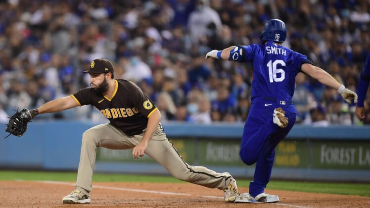 Sep 28, 2021; Los Angeles, California, USA; Los Angeles Dodgers catcher Will Smith (16) is out at first against San Diego Padres first baseman Eric Hosmer (30) during the third inning at Dodger Stadium. Mandatory Credit: Gary A. Vasquez-USA TODAY Sports