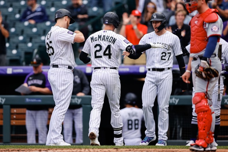 Sep 29, 2021; Denver, Colorado, USA; Colorado Rockies third baseman Ryan McMahon (24) celebrates with shortstop Trevor Story (27) and first baseman C.J. Cron (25) after hitting a three run home run in the first inning against the Washington Nationals at Coors Field. Mandatory Credit: Isaiah J. Downing-USA TODAY Sports
