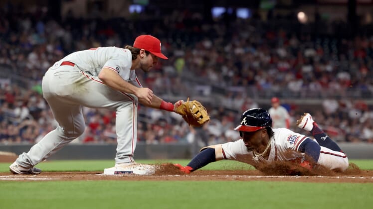 Sep 29, 2021; Atlanta, Georgia, USA; Atlanta Braves second baseman Ozzie Albies (1) slides back to first base safely on a pickoff attempt by Philadelphia Phillies first baseman Matt Vierling (19) during the third inning at Truist Park. Mandatory Credit: Jason Getz-USA TODAY Sports
