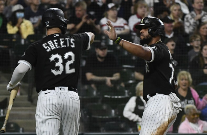 Sep 29, 2021; Chicago, Illinois, USA; Chicago White Sox first baseman Jose Abreu (right) celebrates with designated hitter Gavin Sheets (32) after scoring against the Cincinnati Reds during the fourth inning at Guaranteed Rate Field. Mandatory Credit: Matt Marton-USA TODAY Sports