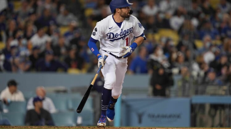 Sep 29, 2021; Los Angeles, California, USA; Los Angeles Dodgers left fielder AJ Pollock (11) watches his two-run home run in the first inning against the San Diego Padres at Dodger Stadium. Mandatory Credit: Kirby Lee-USA TODAY Sports