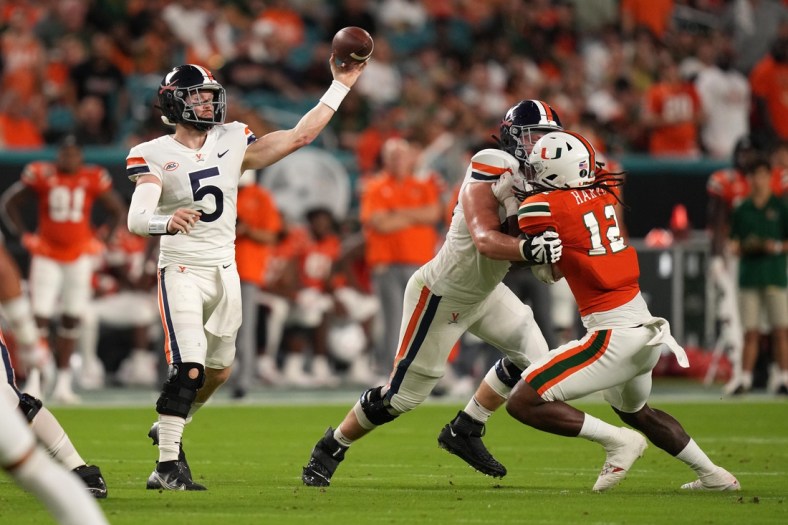 Sep 30, 2021; Miami Gardens, Florida, USA; Virginia Cavaliers quarterback Brennan Armstrong (5) attempts a pass against the Miami Hurricanes during the first half at Hard Rock Stadium. Mandatory Credit: Jasen Vinlove-USA TODAY Sports