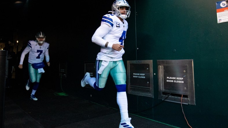 Dec 22, 2019; Philadelphia, Pennsylvania, USA;  Dallas Cowboys quarterback Dak Prescott (4) runs out of the tunnel in front of quarterback Cooper Rush (7) before a game against the Philadelphia Eagles at Lincoln Financial Field. Mandatory Credit: Bill Streicher-USA TODAY Sports