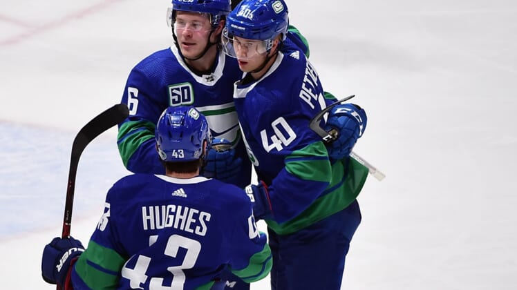 Dec 28, 2019; Vancouver, British Columbia, CAN;  Vancouver Canucks forward Elias Pettersson (40) celebrates his goal  against Los Angeles Kings goaltender Jonathan Quick (32) (not pictured) with Vancouver Canucks defenseman Quinn Hughes (43) and forward Brock Boeser (6) during the third period at Rogers Arena. Mandatory Credit: Anne-Marie Sorvin-USA TODAY Sports