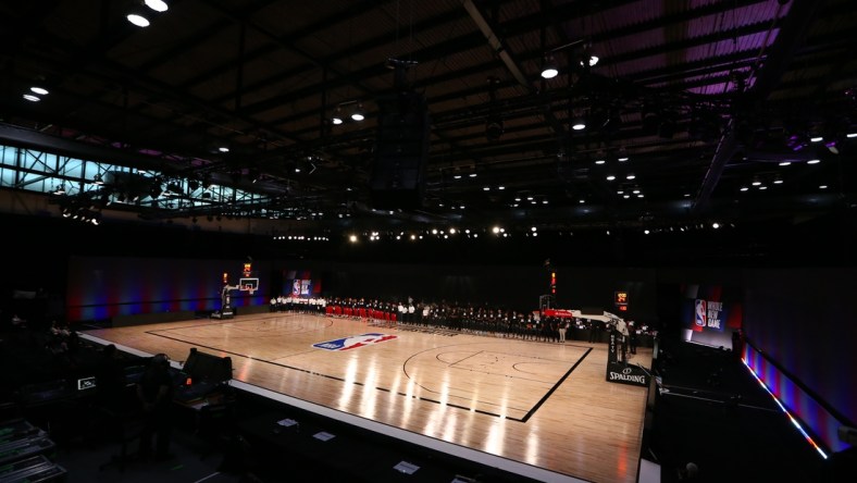 Jul 31, 2020; Lake Buena Vista, Florida, USA; Washington Wizards and Phoenix Suns players kneel behind a Black Lives Matters logo on the court before a NBA basketball game in the Visa Athletic Center at the ESPN Wide World of Sports Complex. Mandatory Credit: Kim Klement-USA TODAY Sports