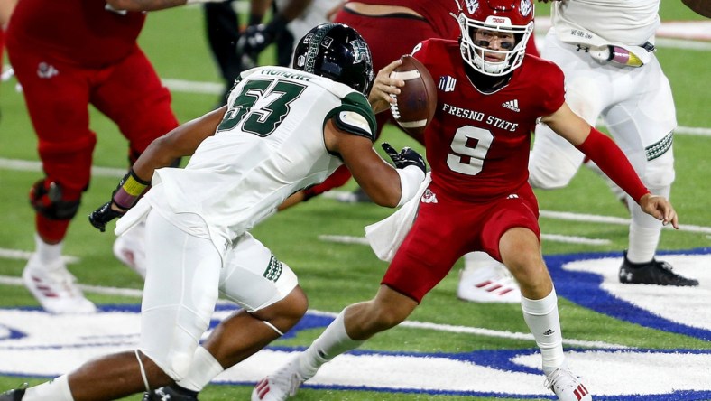 Oct 24, 2020; Fresno, California, USA; Fresno State Bulldogs quarterback Jake Haener (9) rushes the ball against Hawaii Rainbow Warriors linebacker Darius Muasau (53) during the third quarter at Bulldog Stadium. Mandatory Credit: Kiel Maddox-USA TODAY Sports