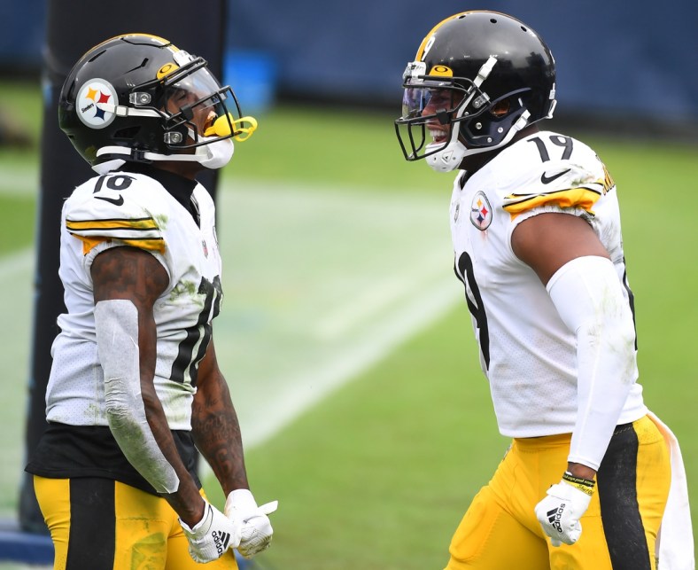 Oct 25, 2020; Nashville, Tennessee, USA; Pittsburgh Steelers wide receiver Diontae Johnson (18) and Pittsburgh Steelers wide receiver JuJu Smith-Schuster (19) celebrate after a touchdown against the Tennessee Titans at Nissan Stadium. Mandatory Credit: Christopher Hanewinckel-USA TODAY Sports