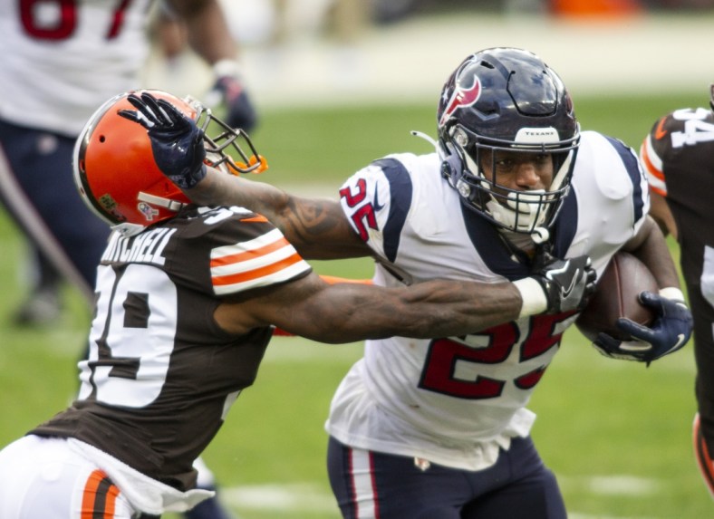 Nov 15, 2020; Cleveland, Ohio, USA; Houston Texans running back Duke Johnson (25) stiff arms Cleveland Browns cornerback Terrance Mitchell (39) as he moves in for the tackle during the second quarter at FirstEnergy Stadium. Mandatory Credit: Scott Galvin-USA TODAY Sports