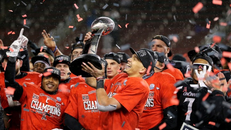 Cincinnati Bearcats quarterback Desmond Ridder (9) raises the championship trophy following the American Athletic Conference championship football game against the Tulsa Golden Hurricane, Saturday, Dec. 19, 2020, at Nippert Stadium in Cincinnati. The Cincinnati Bearcats won, 27-24.

Aac Championship Tulsa Golden Hurricane At Cincinnati Bearcats Football Dec 19