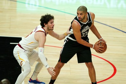 Feb 14, 2021; Los Angeles, California, USA; LA Clippers forward Nicolas Batum (33) is defended by Cleveland Cavaliers forward Cedi Osman (16) in the first half at Staples Center. Mandatory Credit: Kirby Lee-USA TODAY Sports
