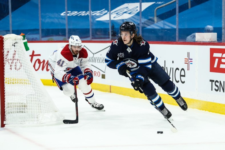 Feb 27, 2021; Winnipeg, Manitoba, CAN;   Winnipeg Jets defenseman Sami Niku (8) skates away from Montreal Canadiens forward Paul Byron (41) during the first period at Bell MTS Place. Mandatory Credit: Terrence Lee-USA TODAY Sports