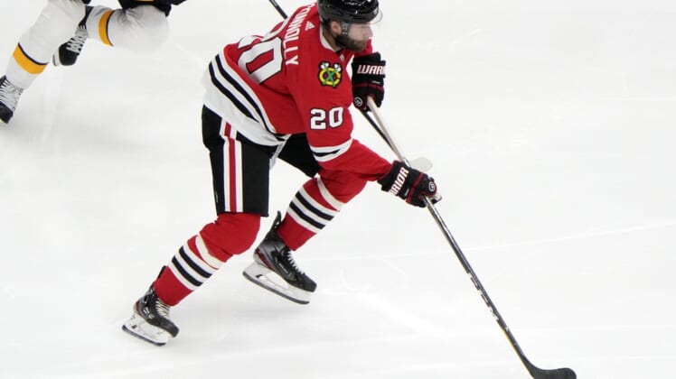 Apr 21, 2021; Chicago, Illinois, USA; Chicago Blackhawks right wing Brett Connolly (20) skates with the puck against the Nashville Predators during the second  period at the United Center. Mandatory Credit: Mike Dinovo-USA TODAY Sports