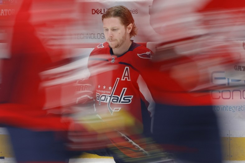 Apr 27, 2021; Washington, District of Columbia, USA; Washington Capitals center Nicklas Backstrom (19) kneels on the ice during warmups prior to the Capitals' game against the New York Islanders at Capital One Arena. Mandatory Credit: Geoff Burke-USA TODAY Sports