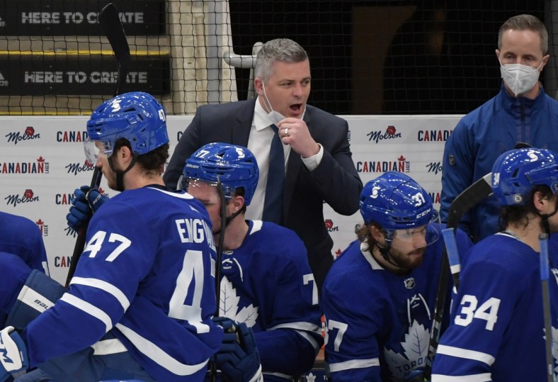 Apr 29, 2021; Toronto, Ontario, CAN;  Toronto Maple Leafs head coach Sheldon Keefe speaks to his players in the third period against the Vancouver Canucks at Scotiabank Arena. Mandatory Credit: Dan Hamilton-USA TODAY Sports