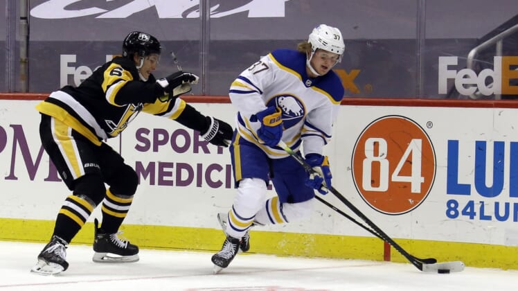 May 8, 2021; Pittsburgh, Pennsylvania, USA;  Buffalo Sabres center Casey Mittelstadt (37) moves the puck against Pittsburgh Penguins defenseman John Marino (6) during the second period at PPG Paints Arena. Mandatory Credit: Charles LeClaire-USA TODAY Sports