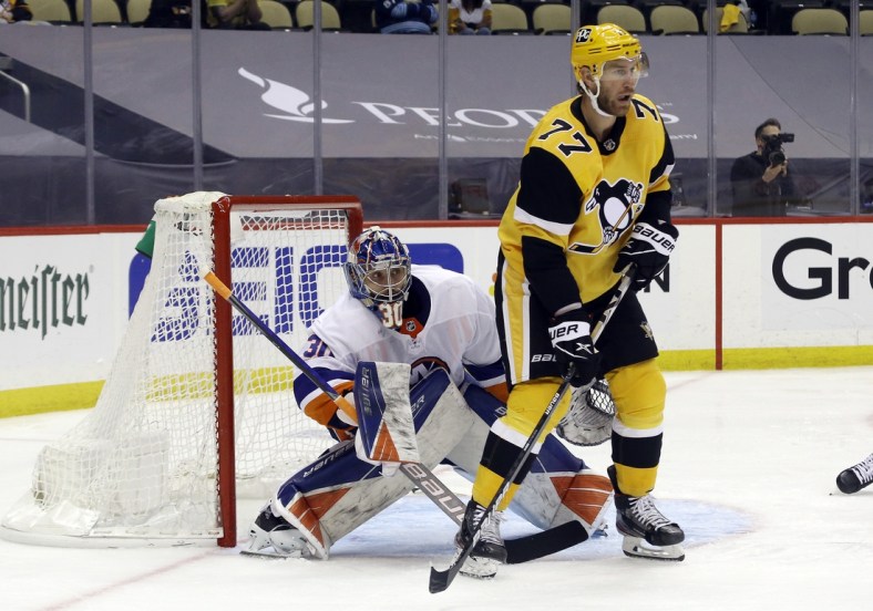 May 24, 2021; Pittsburgh, Pennsylvania, USA;  New York Islanders goaltender Ilya Sorokin (30) looks around a screen by Pittsburgh Penguins center Jeff Carter (77) during the first overtime in game five of the first round of the 2021 Stanley Cup Playoffs at PPG Paints Arena. New York won 3-2 in double overtime. Mandatory Credit: Charles LeClaire-USA TODAY Sports
