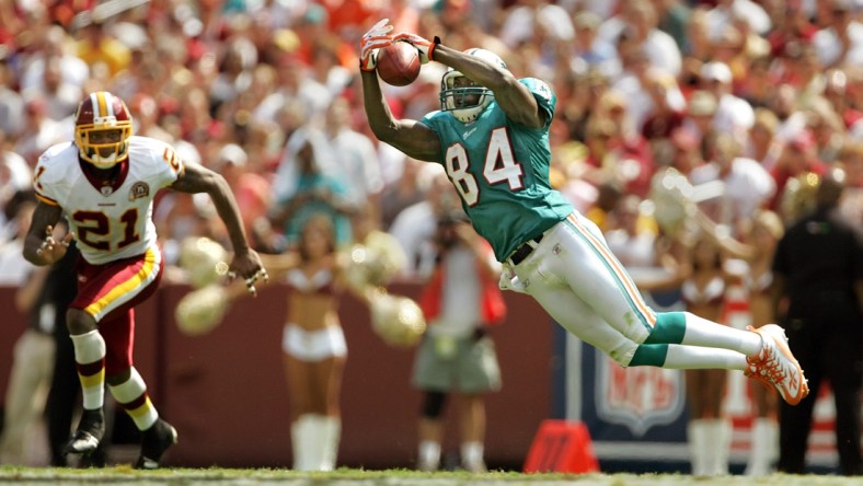 090907 sptdolphins Staff photo by Allen Eyestone/The Palm Beach Post--0042446A--Landover, MD...FedExField...Miami Dolphins at Washington Football Team. Dolphins WR #84 Chris Chambers makes a leaping catch for a first down as Redskins #21 Sean Taylor defends in the second quarter.

090907 Spt Fins Ae 18 Jpg