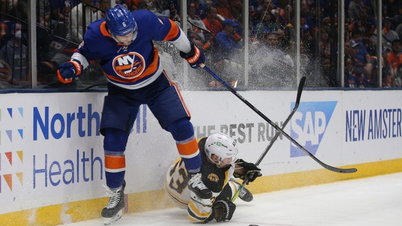 Jun 9, 2021; Uniondale, New York, USA; Boston Bruins center Brad Marchand (63) and New York Islanders defenseman Ryan Pulock (6) fight for the puck during the third period of game six of the third round of the 2021 Stanley Cup Playoffs at Nassau Veterans Memorial Coliseum. Mandatory Credit: Brad Penner-USA TODAY Sports