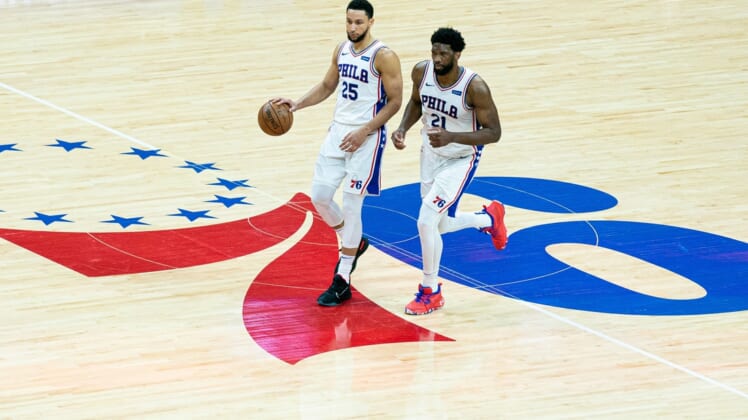 Jun 20, 2021; Philadelphia, Pennsylvania, USA; Philadelphia 76ers center Joel Embiid (21) and guard Ben Simmons (25) in action against the Atlanta Hawks during the second quarter of game seven of the second round of the 2021 NBA Playoffs at Wells Fargo Center. Mandatory Credit: Bill Streicher-USA TODAY Sports