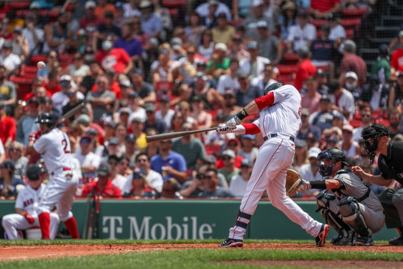 Jun 27, 2021; Boston, Massachusetts, USA; Boston Red Sox designated hitter JD Martinez (28) hits a home run during the third inning against the New York Yankees at Fenway Park. Mandatory Credit: Paul Rutherford-USA TODAY Sports
