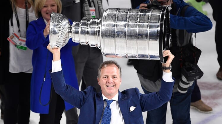 Jul 7, 2021; Tampa, Florida, USA; Tampa Bay Lightning head coach Jon Cooper hoists the Stanley Cup after the Lightning defeated the Montreal Canadiens 1-0 in game five to win the 2021 Stanley Cup Final at Amalie Arena. Mandatory Credit: Douglas DeFelice-USA TODAY Sports