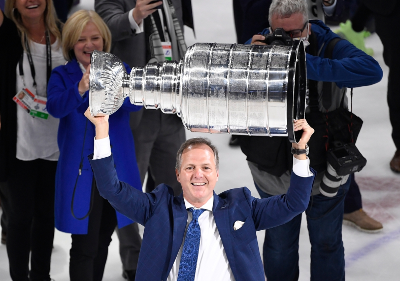 Jul 7, 2021; Tampa, Florida, USA; Tampa Bay Lightning head coach Jon Cooper hoists the Stanley Cup after the Lightning defeated the Montreal Canadiens 1-0 in game five to win the 2021 Stanley Cup Final at Amalie Arena. Mandatory Credit: Douglas DeFelice-USA TODAY Sports