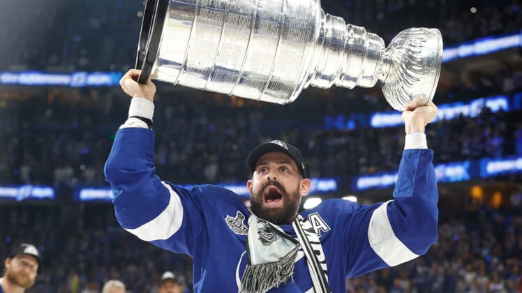 Jul 7, 2021; Tampa, Florida, USA;  Tampa Bay Lightning left wing Alex Killorn (17) hoists the Stanley Cup after the Lightning defeated the Montreal Canadiens 1-0 in game five to win the 2021 Stanley Cup Final at Amalie Arena. Mandatory Credit: Kim Klement-USA TODAY Sports