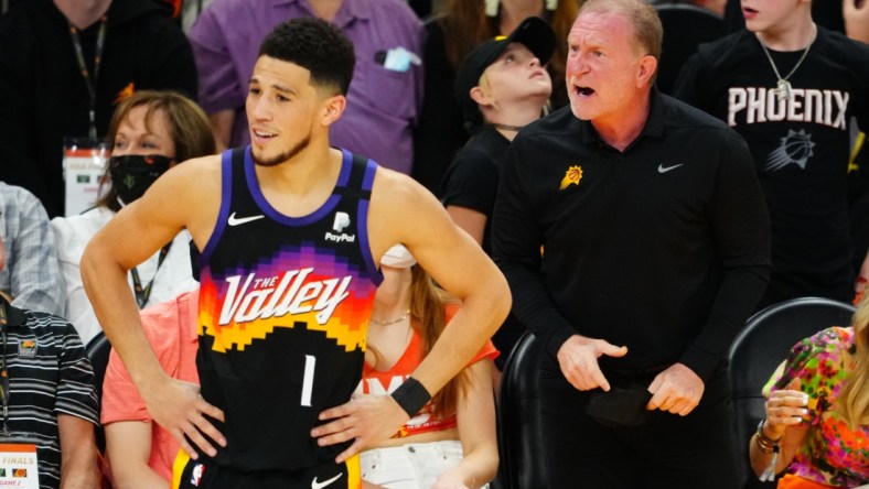 Jul 8, 2021; Phoenix, Arizona, USA; Phoenix Suns owner Robert Sarver reacts alongside guard Devin Booker (1) against the Milwaukee Bucks in game two of the 2021 NBA Finals at Phoenix Suns Arena. Mandatory Credit: Mark J. Rebilas-USA TODAY Sports