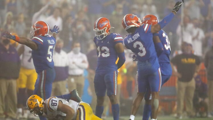 After a tackle Florida Gators defensive back Marco Wilson (3) throws the shoe of LSU tight end Kole Taylor (87) which resulted in a personal foul penalty against Wilson, during a game against the LSU Tigers at Ben Hill Griffin Stadium in Gainesville, Fla. Dec. 12, 2020. Florida lost 37-34 to the Tigers.Sports Mcclenny02
