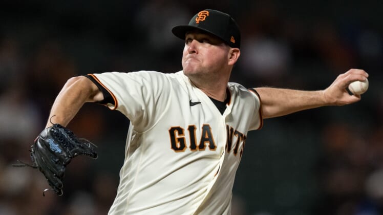 Aug 16, 2021; San Francisco, California, USA; San Francisco Giants relief pitcher Jake McGee (17) throws against the New York Mets in the ninth inning at Oracle Park. Mandatory Credit: John Hefti-USA TODAY Sports