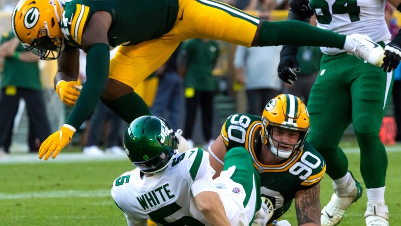 Green Bay Packers linebacker Chauncey Rivers (47) leaps over New York Jets quarterback Mike White (5) after White was tackled by Green Bay Packers' Jack Heflin (90)  in the second half during their preseason football game on Saturday, August 21, 2021, at Lambeau Field in Green Bay, Wis.

Mjs Gpg Heflin 08212021 0020