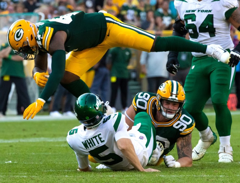Green Bay Packers linebacker Chauncey Rivers (47) leaps over New York Jets quarterback Mike White (5) after White was tackled by Green Bay Packers' Jack Heflin (90)  in the second half during their preseason football game on Saturday, August 21, 2021, at Lambeau Field in Green Bay, Wis.

Mjs Gpg Heflin 08212021 0020